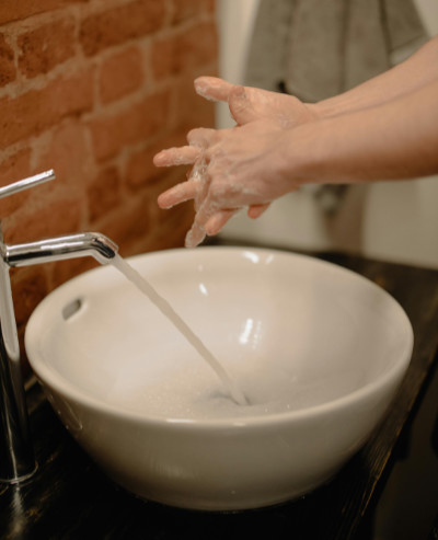 a person washes their hands at a sink